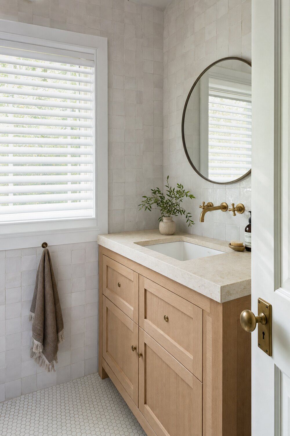 Horizontal blinds tilted open in a bright room