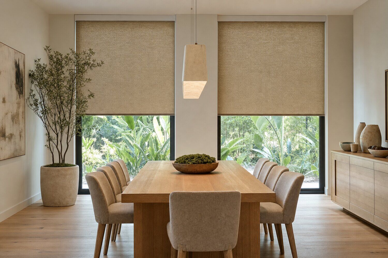 Motorized shades across a window wall in a double-height room