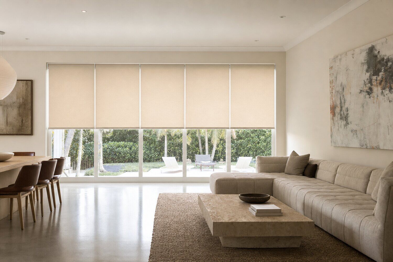 A bright room with fabric shades lowered against the light