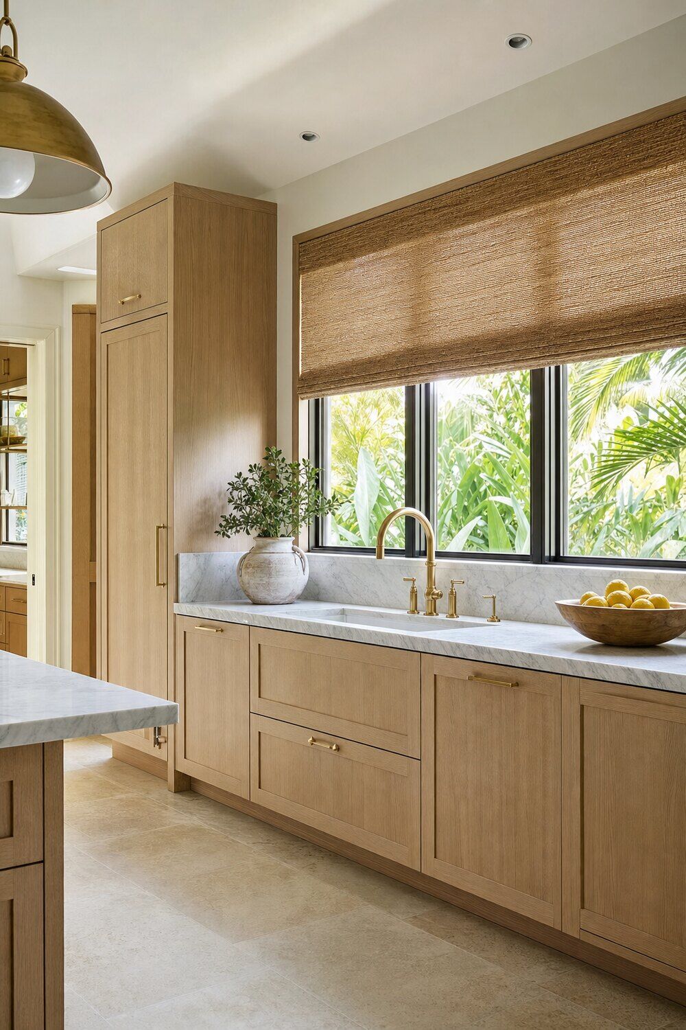 A double-height room with fabric shades lowered against the light