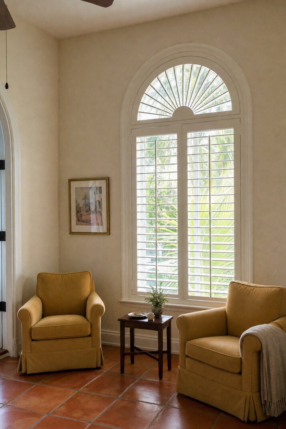 An unusually shaped window treated to follow its outline in a sunlit room
