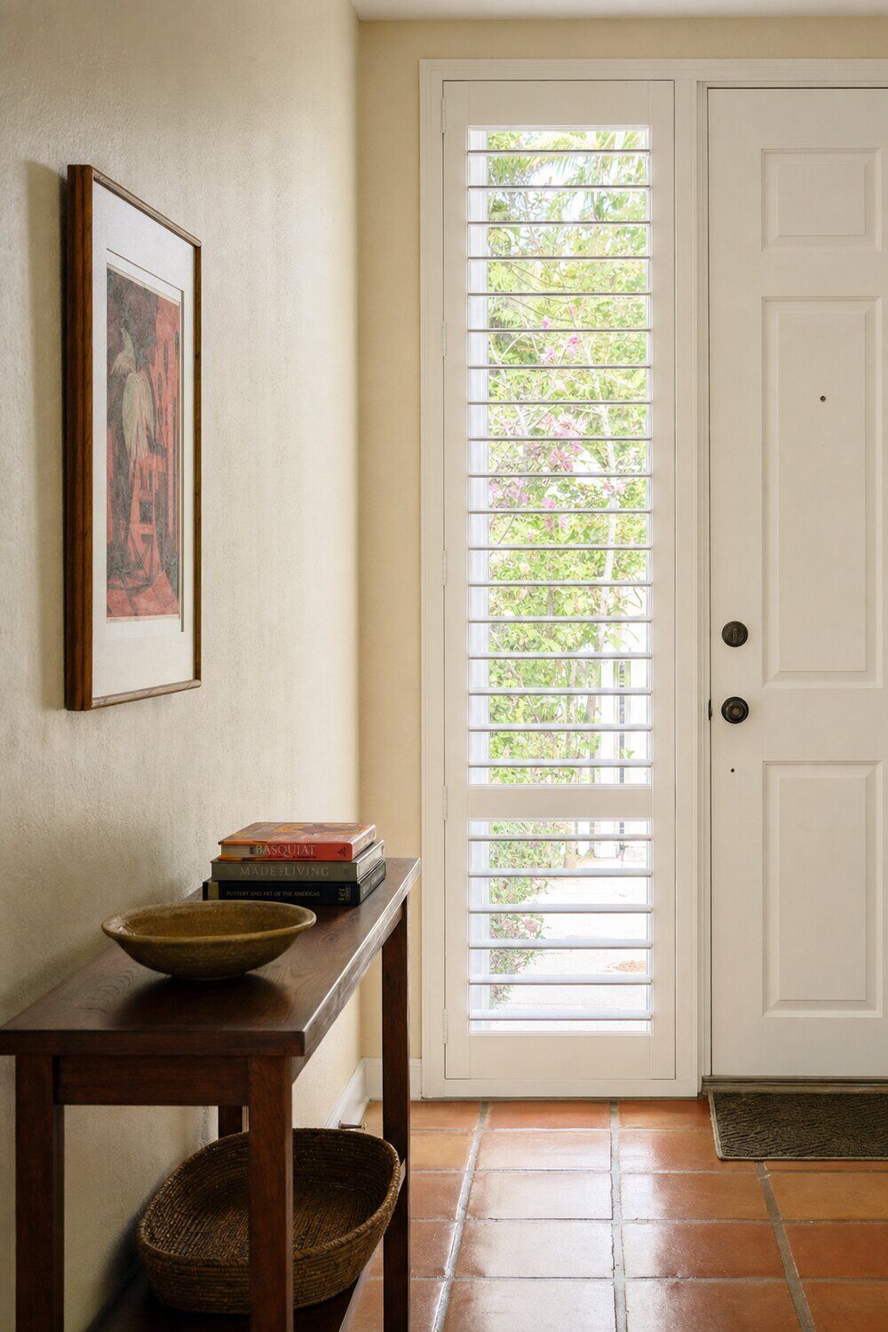 Interior shutters with the louvers angled in a paneled room