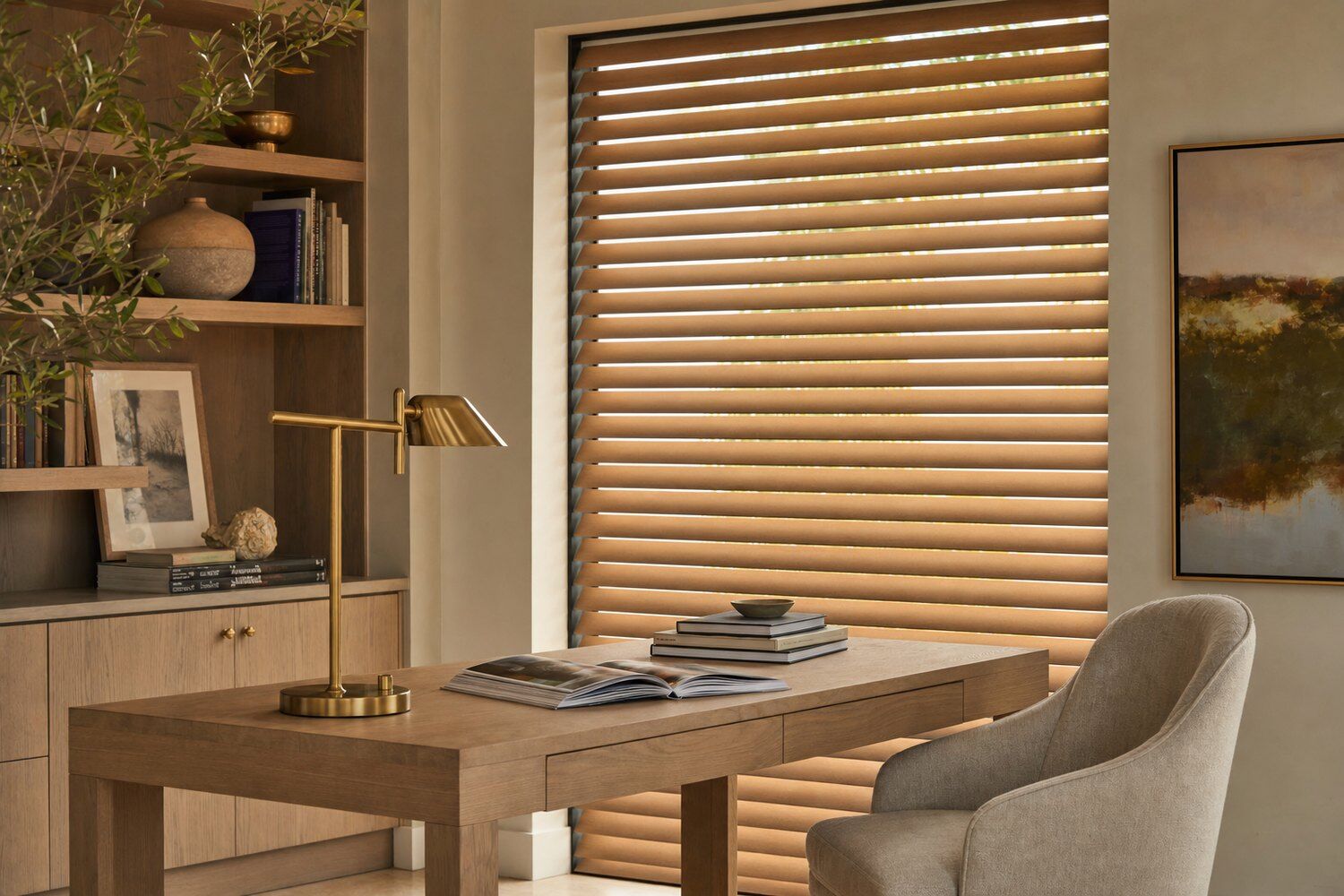 A study in afternoon light with motorized warm oak wood blinds across a tall window behind a white oak desk, louvers tilted down at a precise even angle
