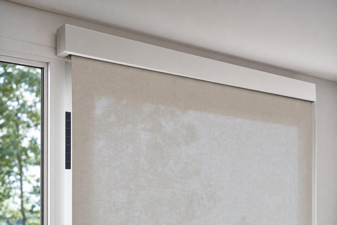 A close view of a slim white cassette with no cords, chain, or wand of any kind, the bone linen dropping from it in one plane